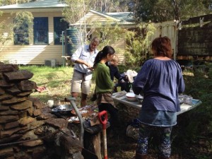 Spirit of Play teachers helping prepare an outdoor meal